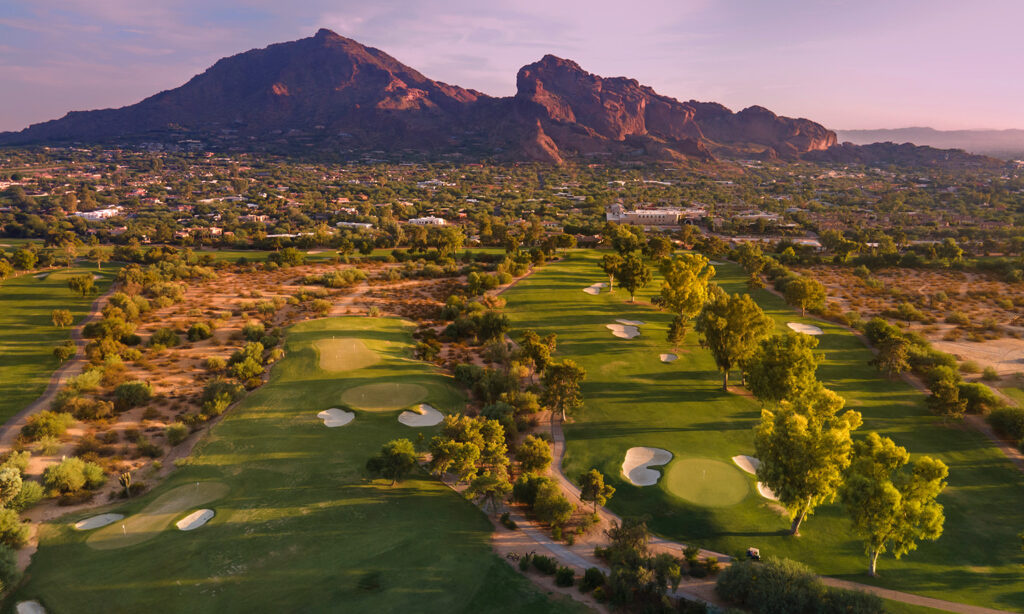 Late evening sun glowing red on Camelback Mountain in Phoenix, book your Phoenix retnal van and experience all this desert southwest community has to offer on a spectacular golf vacation!